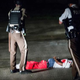 Police come upon a man lying in a parking lot with what appears to be gunshot wounds after a barrage of gunfire erupted along West Florissant Avenue in Ferguson, Mo., during a demonstration Aug. 9, 2015, to mark the one-year anniversary of the police shooting of Michael Brown.
Scott Olson/Getty Images